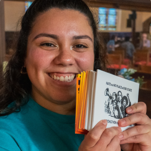 Girl showing info on Husky4Immigrants